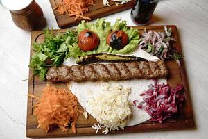 Wooden Cutting Board With Assorted Meats and Fresh Vegetables photo