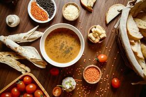 Wooden Table With Assorted Soups and Bread photo