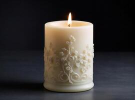 AI generated Lit ivory candle with floral embossing, casting a soft glow against a dark background photo