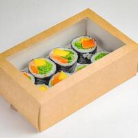 Cardboard Box Filled With Sushi and Vegetables photo