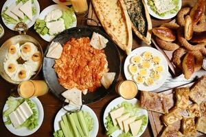 Wooden Table Adorned With Platters of Food photo