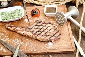 Juicy Slice of Steak on a Wooden Cutting Board photo