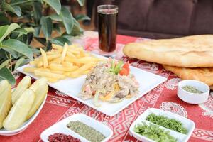 Table With Food Plates and Beer Bottle photo