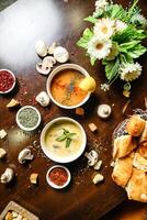 Table Adorned With Bowls of Steaming Soup and Fresh Bread. photo