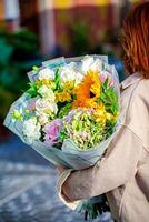 Woman Holding Bouquet of Flowers photo