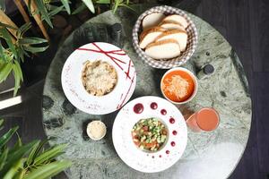 Table Displaying Assorted Plates of Food and Drinks photo