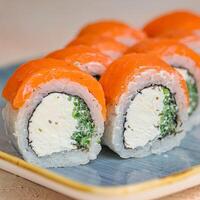 Plate of Sushi on Wooden Table photo