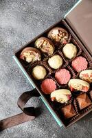 Assorted Chocolates Box Resting on Table photo