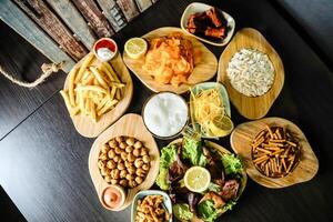 Wooden Table Topped With Plates of Food photo