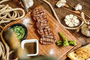 Wooden Cutting Board With Assorted Meat and Vegetables photo