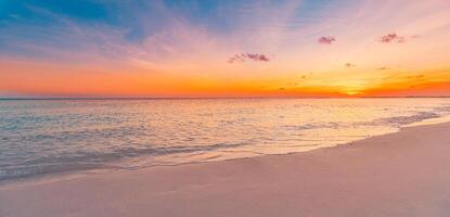 Closeup sea sand beach. Panoramic beach landscape. Inspire calm tropical seascape horizon. Colorful sunset sky clouds tranquil relax sunlight summer sunrise mood. Vacation travel holiday destination photo