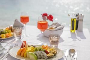 Luxury breakfast table beautiful tropical sea sky background. Idyllic romantic morning love couples time at summer holiday. Honeymoon romance vacation concept. Travel and lifestyle, destination dining photo