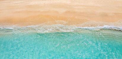 Relaxing aerial beach scene, summer vacation holiday template banner. Waves surf with amazing blue ocean lagoon, sea shore, coastline. Perfect aerial drone top view. Peaceful bright beach, seaside photo