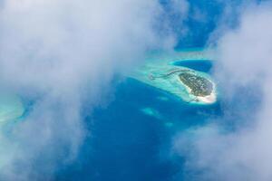 Aerial view on Maldives island, Ari atoll. Tropical islands and atolls in Maldives from aerial view. Summer vacation holiday landscape background. photo