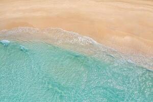 Relaxing aerial beach scene, summer vacation holiday template banner. Waves surf with amazing blue ocean lagoon, sea shore, coastline. Perfect aerial drone top view. Peaceful bright beach, seaside photo