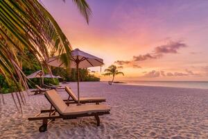 Tranquil sea sand sunset sky relaxing beach. Love couple romantic freedom travel tourism landscape. Idyllic exotic chairs umbrella, palm tree leaves, tropics beachfront resort. Summer vacation island photo