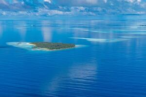 Aerial view on Maldives island, Ari atoll. Tropical islands and atolls in Maldives from aerial view. Summer vacation holiday landscape background. photo