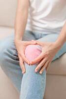 woman having knee ache and muscle pain due to Runners Knee or Patellofemoral Pain Syndrome, osteoarthritis, arthritis, rheumatism and Patellar Tendinitis. medical concept photo