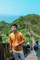man traveler visiting in Taiwan, Tourist sightseeing in Bitou Cape Hiking Trail, New Taipei City. landmark and popular attractions near Taipei. Asia Travel concept photo