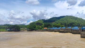 view of serayu river with big current, river landscape at day photo