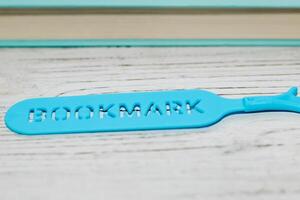 Blue stationery bookmark in the shape of a palm. photo