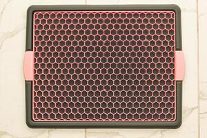 A tray with a grid for drying dishes, a convenient kitchen device. photo