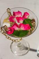 Rose petals in a martini glass, concept of beauty, style and fashion photo