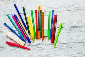 Stationery, colored felt-tip pens on a white table. photo