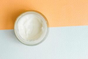 Moisturizing spf cream in a jar on a light background. photo