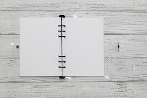 Notebook with rings, checkered sheets, transparent cover, study concept. photo