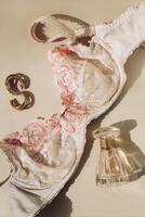 Perfume bottle and silk elastic band on a golden background, beauty routine photo