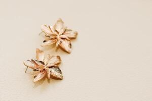 Gold ornaments from yellow metal on a light background. photo