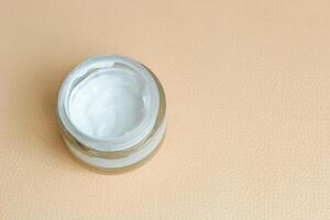 Moisturizing spf cream in a jar on a light background. photo