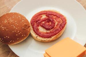 Homemade burger buns with ketchup lie on a plate. photo