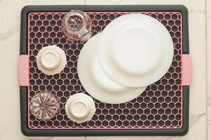 A tray with a grid for drying dishes, a convenient kitchen device. photo