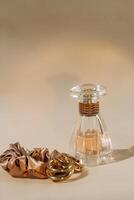 Perfume bottle and silk elastic band on a golden background, beauty routine photo
