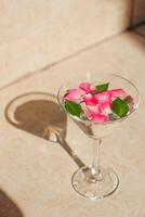 Rose petals in a martini glass, concept of beauty, style and fashion. photo