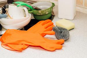 A pile of dirty dishes, cups, plates in the sink. photo