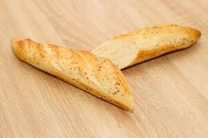 Fresh baguette made of white wheat flour with seeds and cereals photo