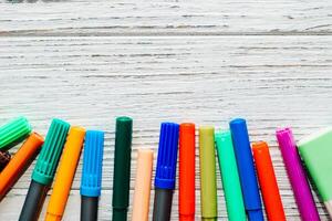 Stationery, colored felt-tip pens on a white table. photo