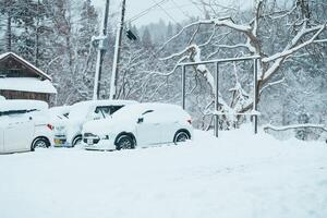 Car park at Ginzan Onsen with snow fall in winter season is most famous Japanese Hot Spring in Yamagata, Japan. Yamagata, Japan, 24 January 2024 photo