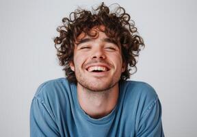 AI generated Man laughing with curly hair and blue shirt on white background, people laughing picture photo