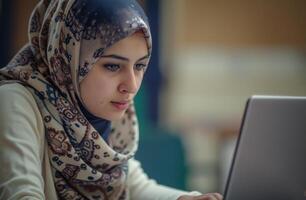 AI generated Muslim woman in headscarf looks at laptop screen, ramadan at workplaces picture photo