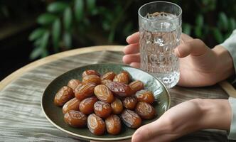 ai generado plato de fechas y un vaso de agua participación manos, islámico tradicional ropa imagen foto