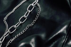 Chain on black texture eco soft leather, fashionable jacket photo