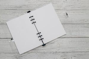 Notebook with rings, checkered sheets, transparent cover, study concept. photo