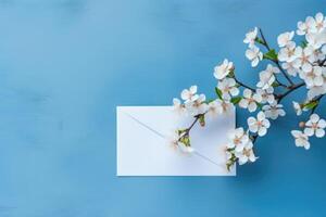 AI generated Cherry tree blossom, branches with white spring flowers and envelope over blue background photo