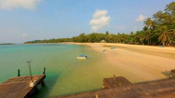 FPV flight over wooden pier, white beach and turquoise water, Koh Mak Thailand video