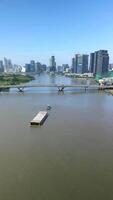 Aerial of barge on the Saigon River and Ho Chi Minh City skyline, Vietnam video