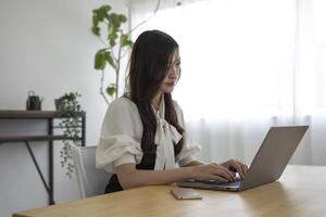 A working Japanese woman by remote work in the home office closeup photo